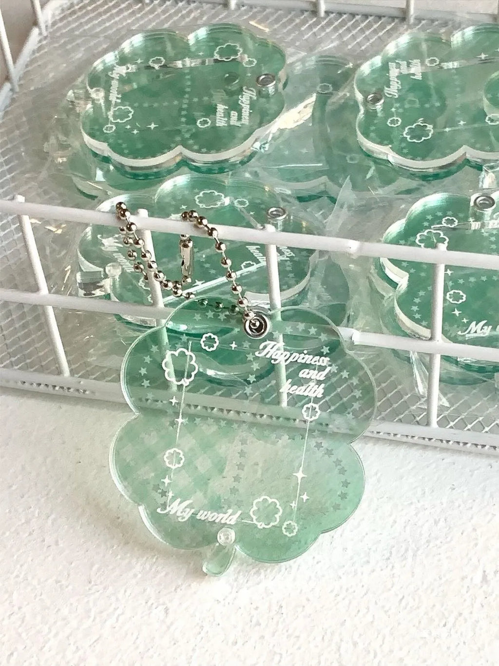 Acrylic four-leaf clover shape mobile phone pendant keychain in blue or green.