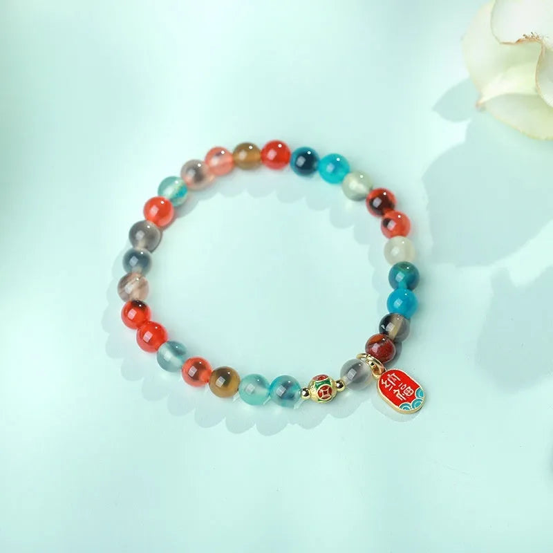 Women's agate snake bracelet with copper coin detailing and coloured glaze accents in geometric design