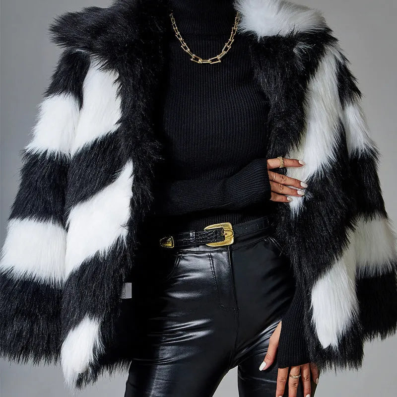 Women's beige faux fur lapel coat with a dark contrast fur collar on a hanger.