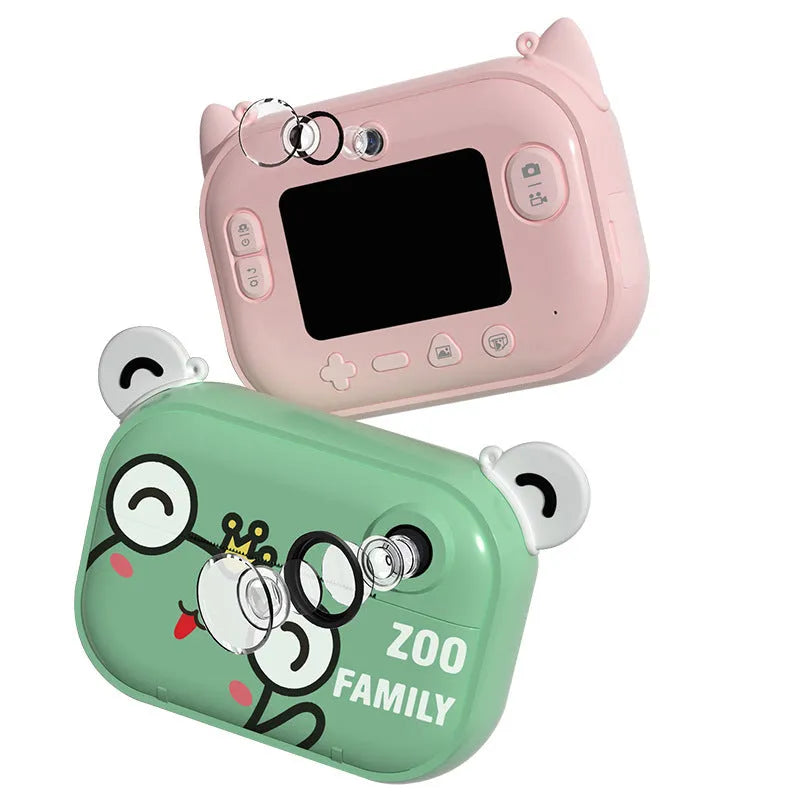 Blue instant print digital camera with 2.4-inch LCD screen, printing paper, and accessories on a table.