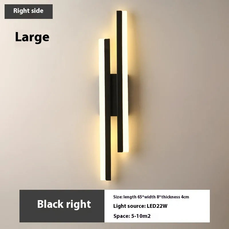 Scandinavian minimalist LED wall light with an acrylic shade on a black arm, mounted on a light-coloured wall.