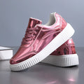 Gold platform sneaker with sequin upper and thick MD sole on a white background.