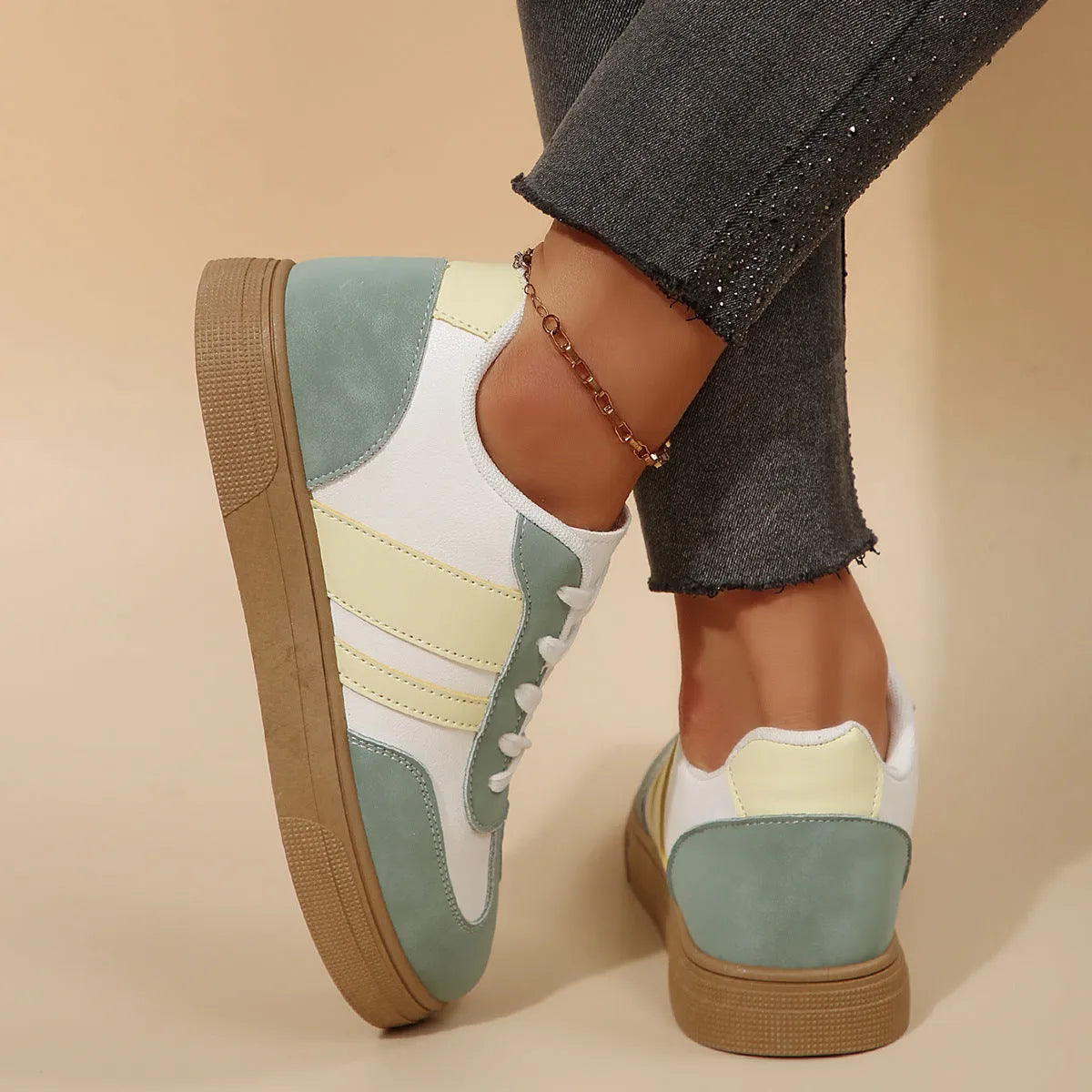 Green women's low-top casual pumps with cross-strap design and flat rubber sole.