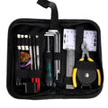 Black guitar repair and care tool kit with plastic and metal tools for instrument maintenance.