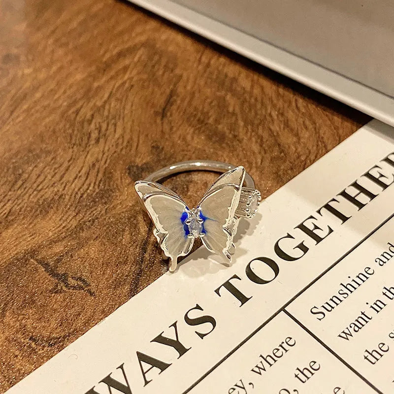 Copper butterfly women's ring with drip oil finish in an open-loop design.