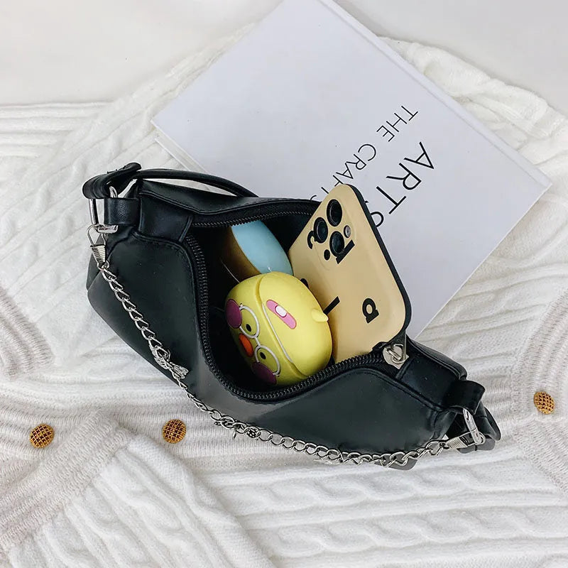 Women's black butterfly chain underarm bag with crossbody strap, showing structured square shape and retro style.