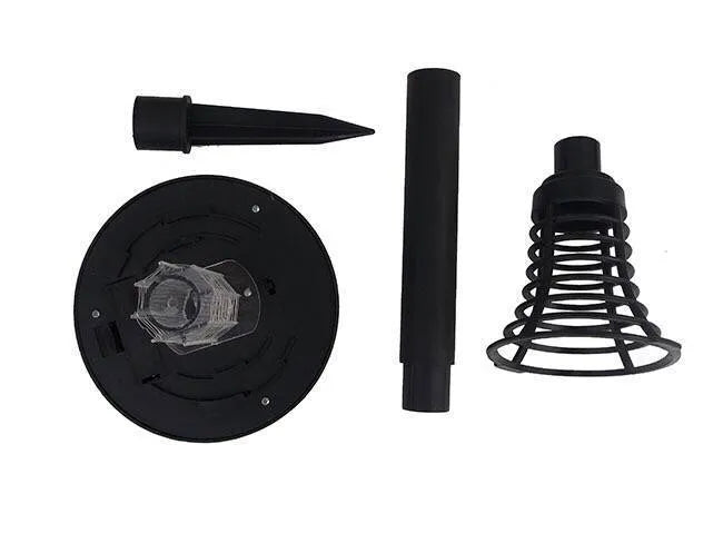 Black solar powered insect killing mosquito lawn lamp with white and purple light LEDs in a garden setting.