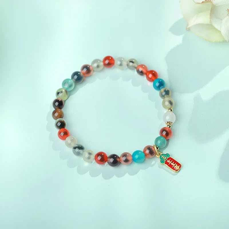 Women's agate snake bracelet with copper coin detailing and coloured glaze accents in geometric design