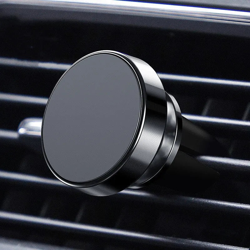 Black magnetic car phone holder with flexible arm mounted on a car air vent.