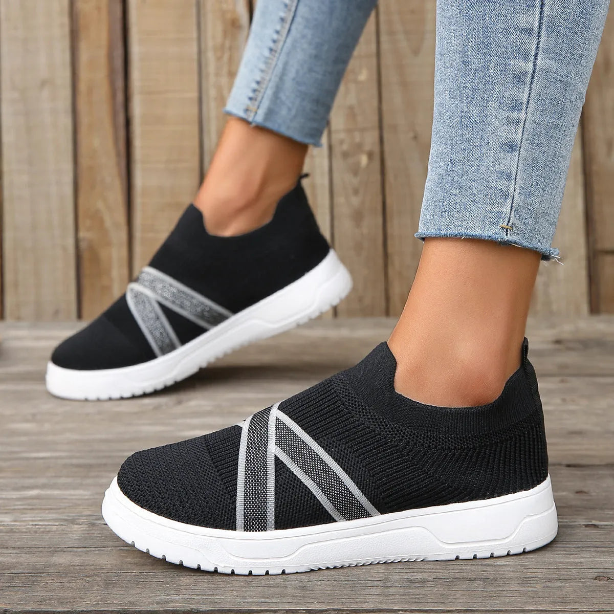 Black women's flyknit mesh casual shoes with flat rubber sole and round toe.