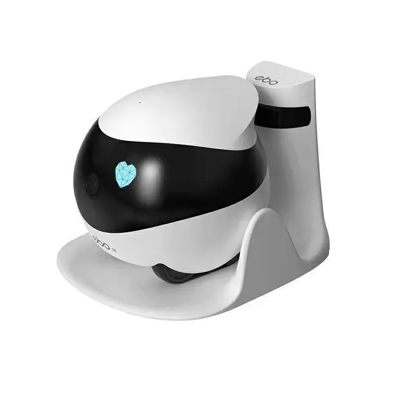 White smart home mobile surveillance robot camera next to its automatic charging docking station.