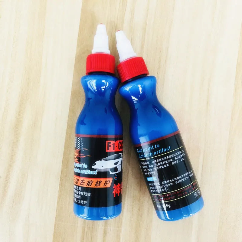 Blue car scratch repair kit with bottle of repair agent and application tool for automotive paint touch-ups