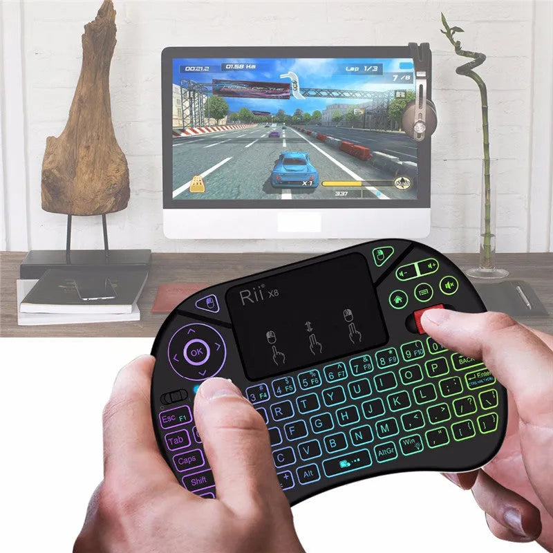 i8X black wireless keypad with 71-key QWERTY keyboard, touchpad, dual mouse buttons and lithium battery