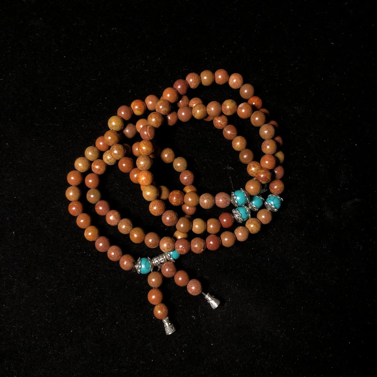 Stone bracelet with 108 geometric beads showing hand-polished finish
