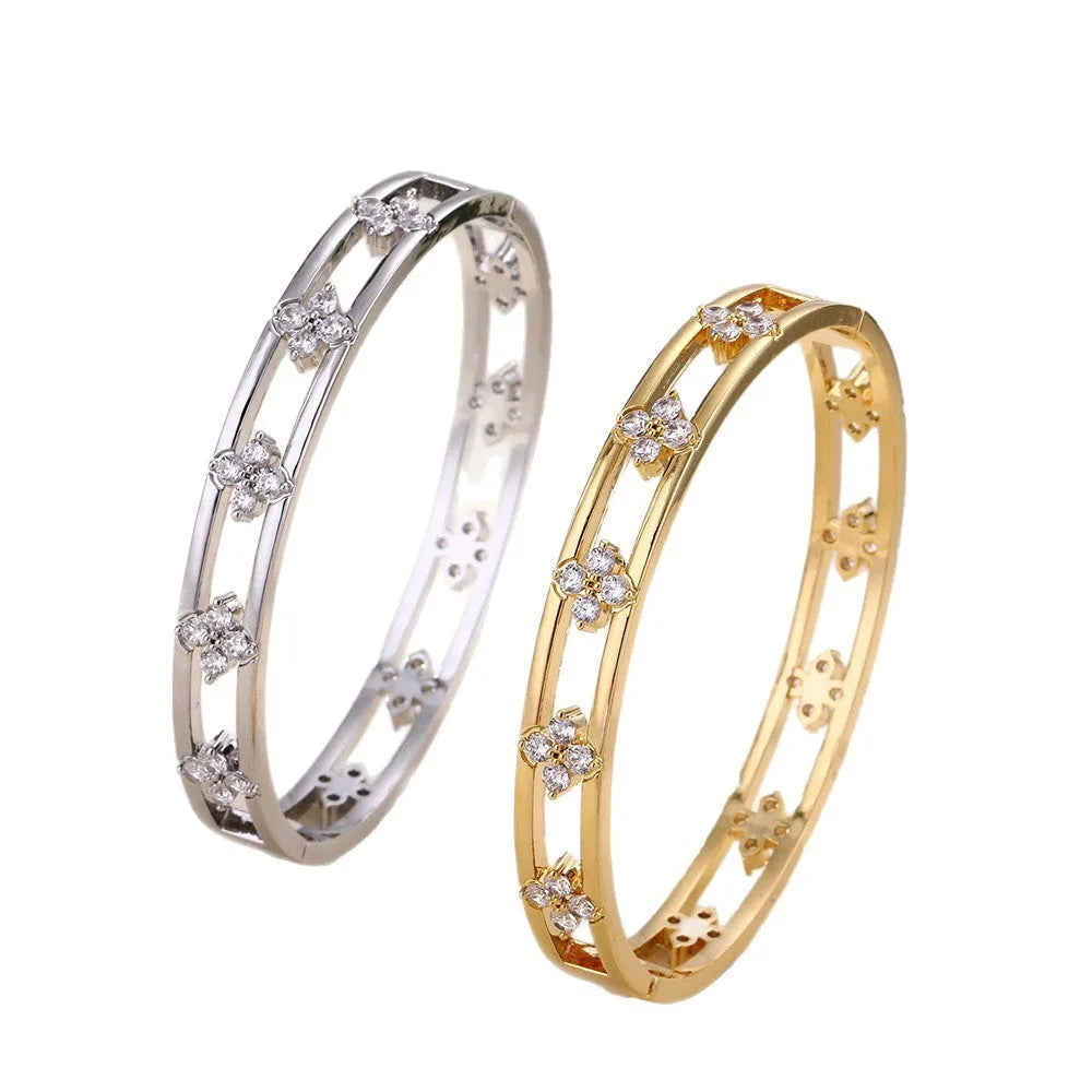 Women's hollow bracelet with a four-leaf clover zircon charm on an adjustable band, shown in gold and silver finishes.