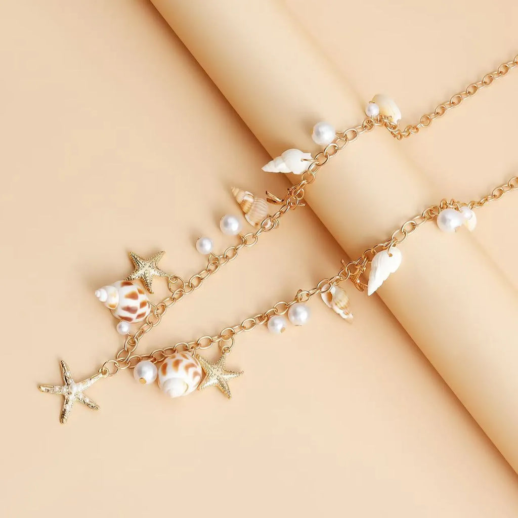 Women's alloy waist chain and matching bracelet with shell and star decorations.