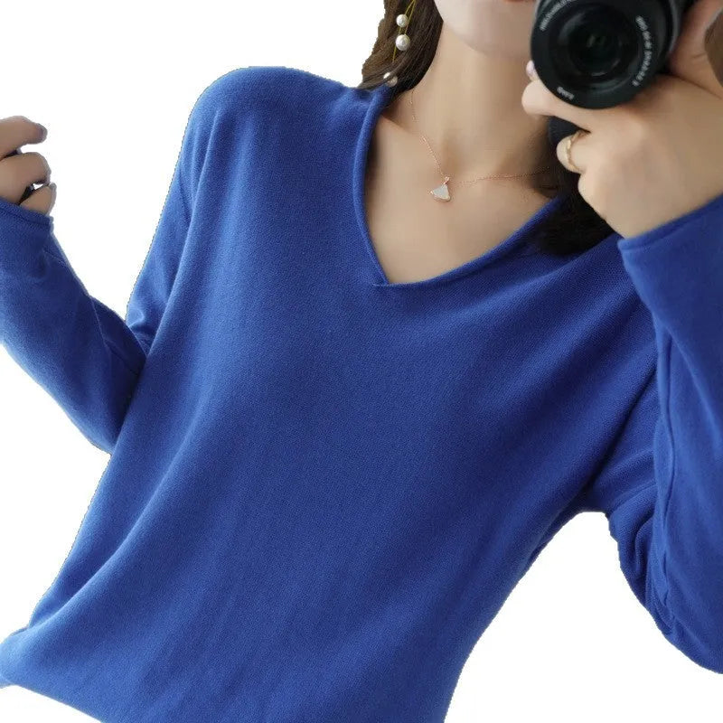 Women's turmeric V-neck long sleeve knitwear top laid flat.