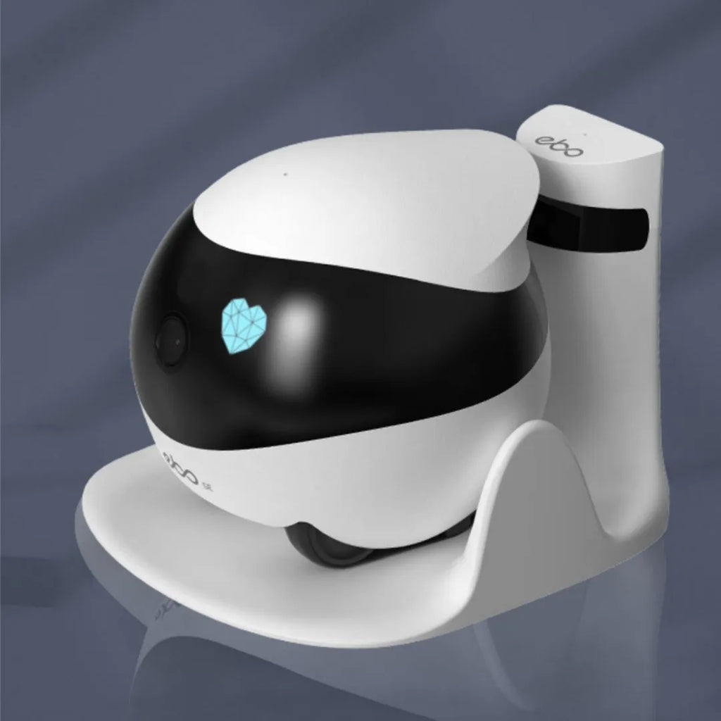 White smart home mobile surveillance robot camera next to its automatic charging docking station.