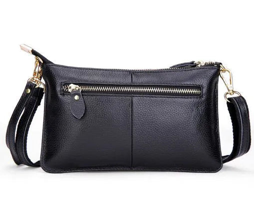 Lady's cowhide slant bag with hand strap and long shoulder strap shown in multiple colours.