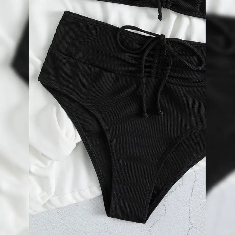 Black women's bikini swimsuit with high-waist shorts and sling split design.