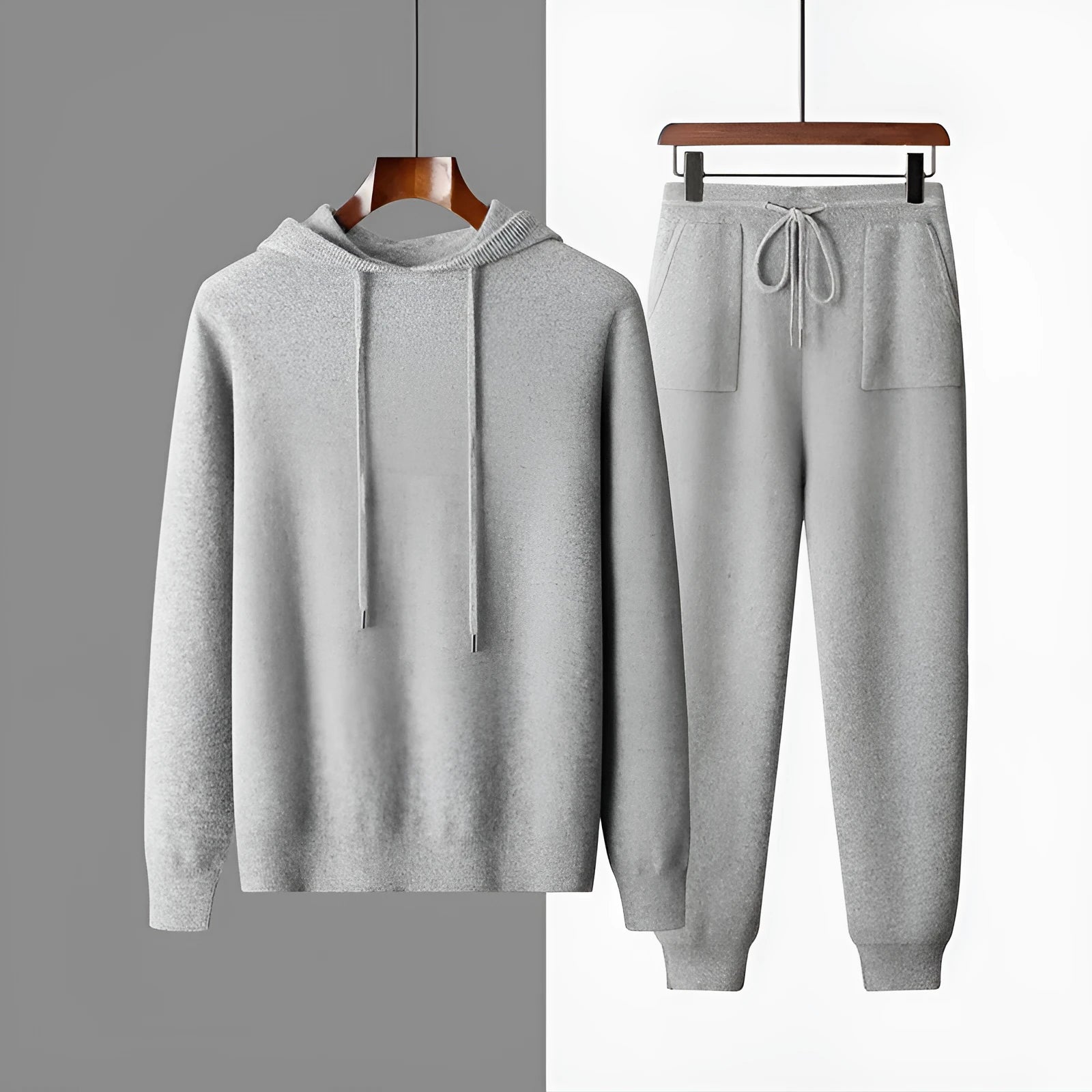 Men's light grey cashmere hooded sweatshirt and matching long pants laid flat.