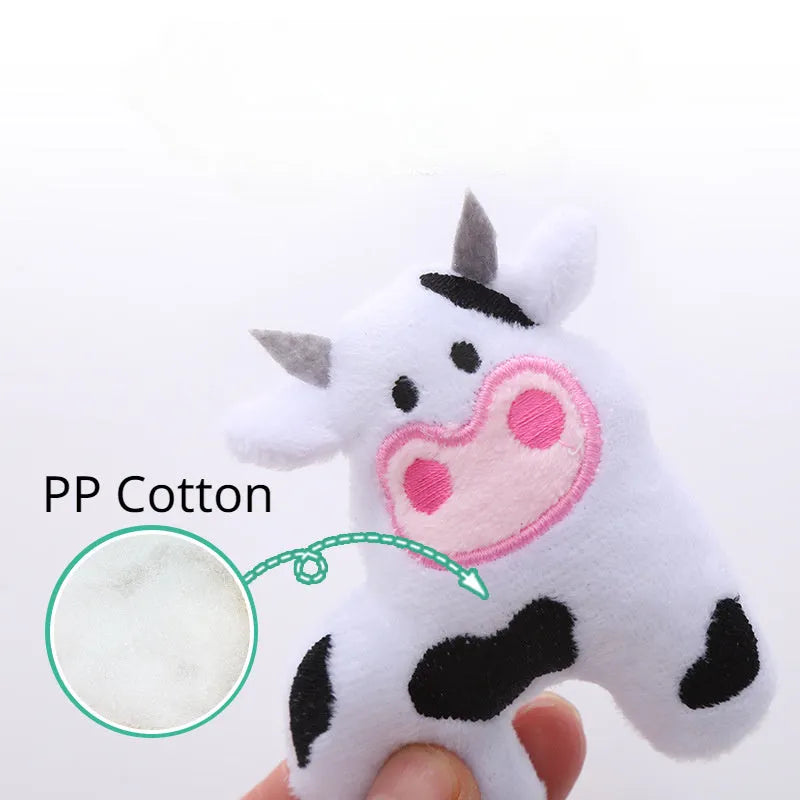 Plush cat toy in shape of a cow, a crocodile, and a parrot on a plain background.