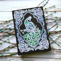 Black A5 diamond painting notebook with shaped and bright rhinestone designs on the cover.