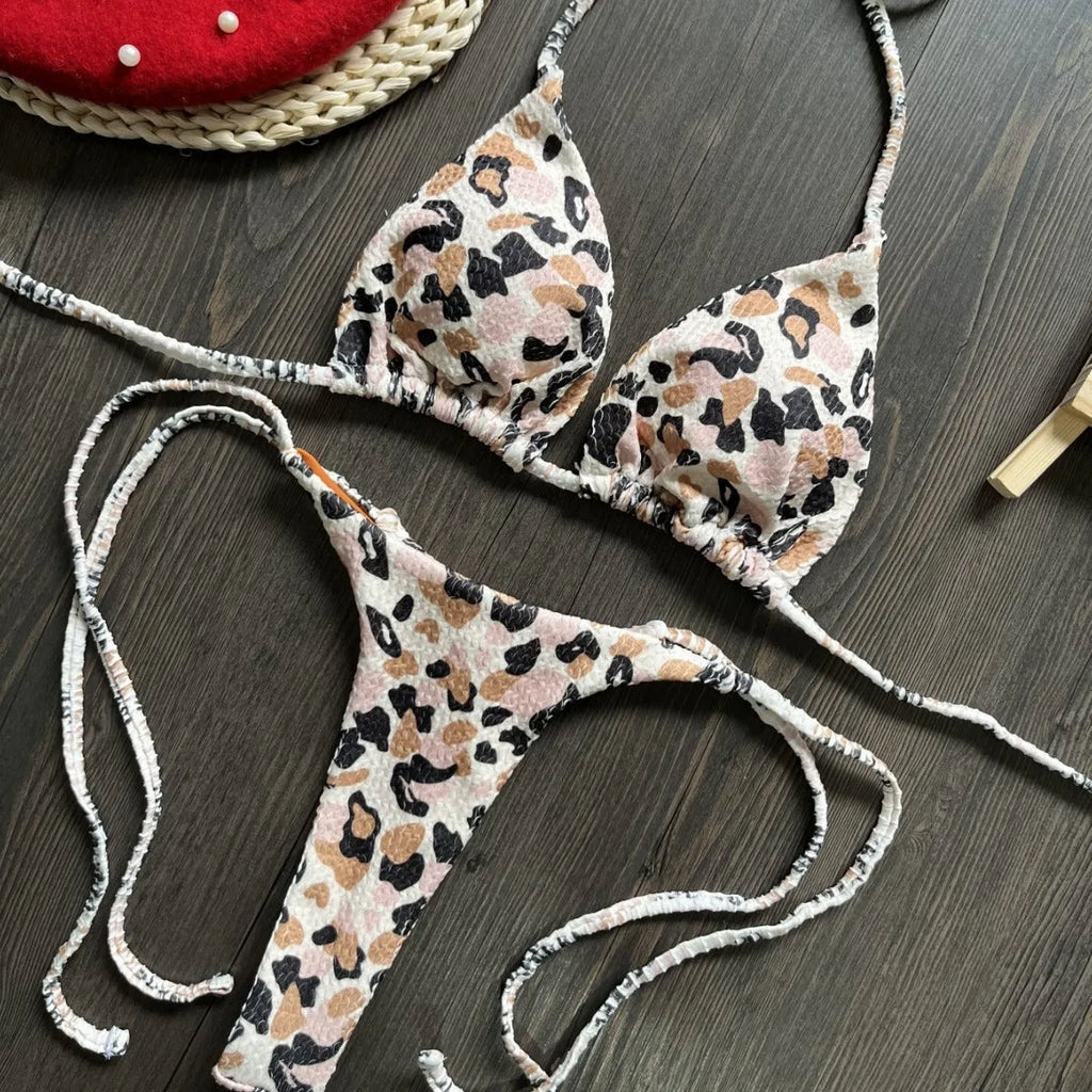 Women's printed bikini swimsuit set on a hanger, showing quick-dry fabric and cotton-lined briefs.