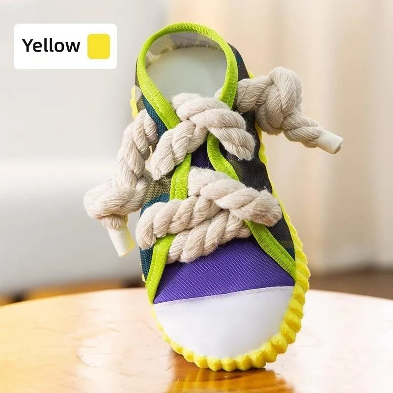 Realistic shoe-shaped dog toy in grey, purple, or yellow with laces, sole patterns, built-in squeaker and bell.