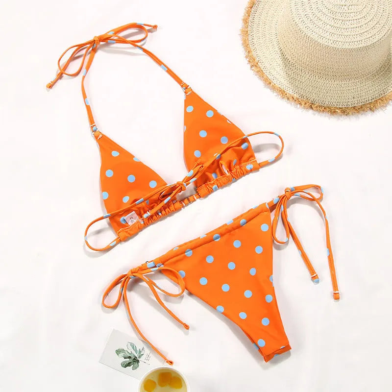 Women's polka dot print split swimsuit bikini set in polyester on a mannequin.