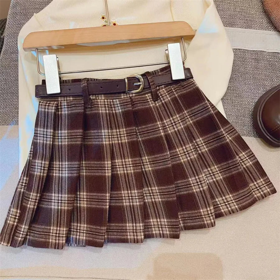 Girls plaid pleated A-line skirt in cotton-blend fabric, shown on a hanger.
