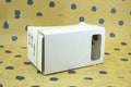 Cardboard VR glasses for smartphones with 3D lenses, showing pink colour option