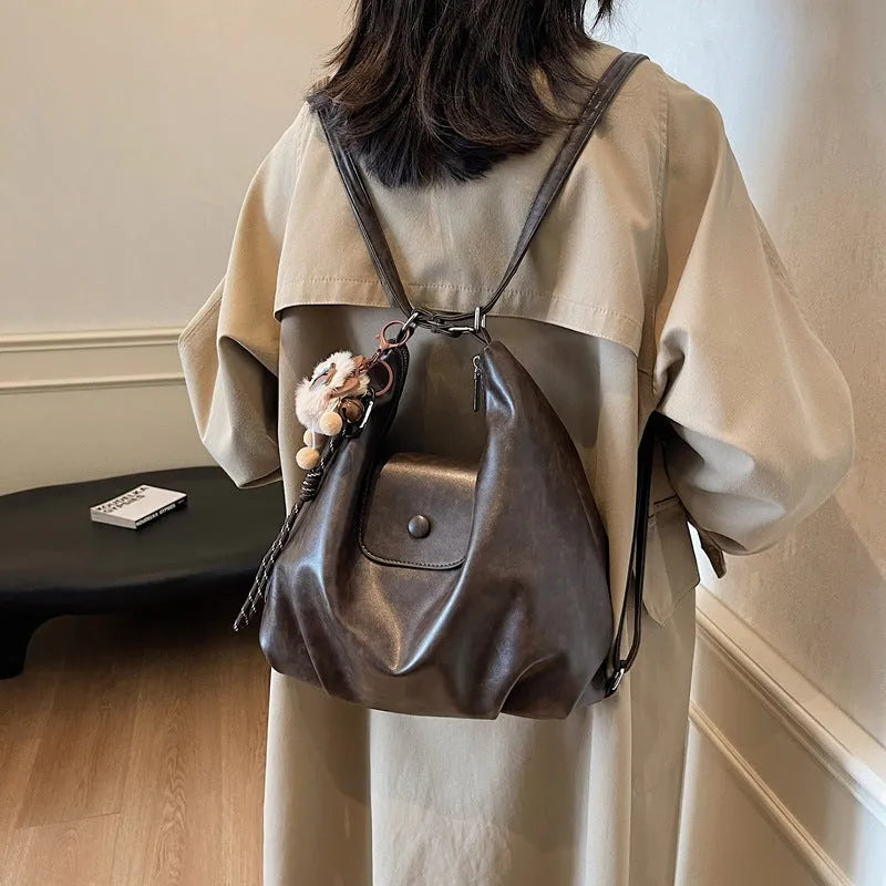 Black leather PU women's single-shoulder backpack with textured finish and horizontal square shape