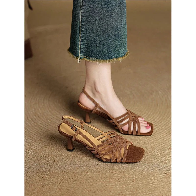 Retro women's sandals with thin cross straps, ankle buckle, square toe, and a mid heel.