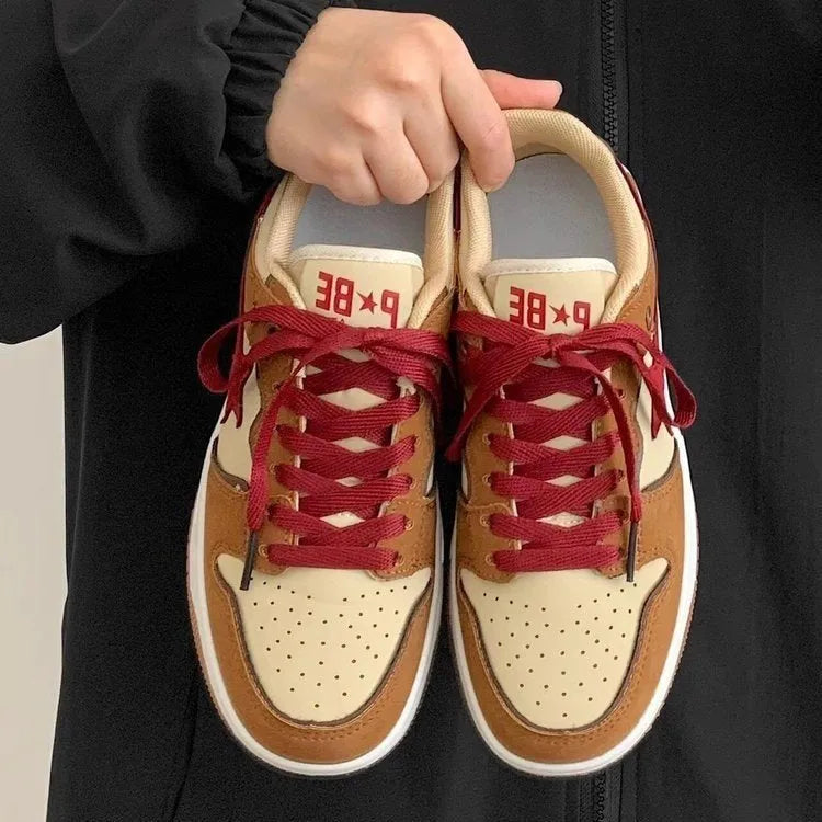 Brown women's low-top sneakers with sequin trim and platform heel on rubber sole.