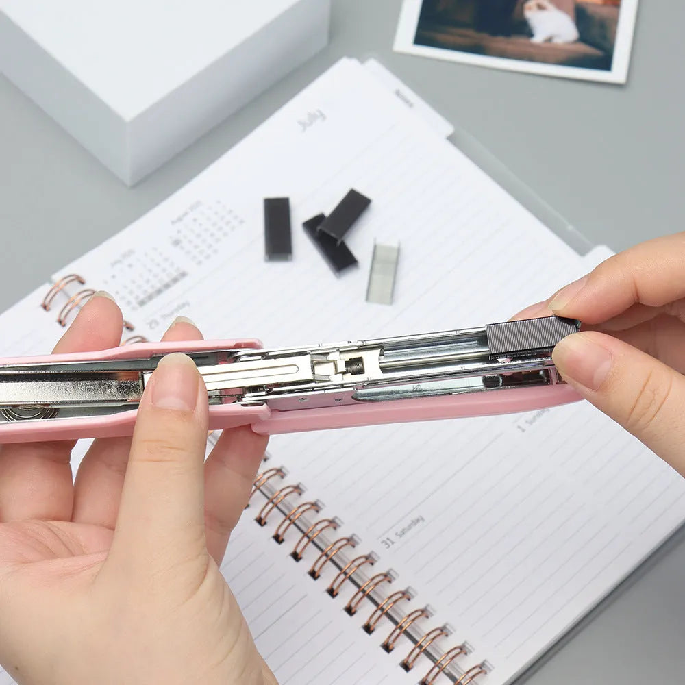 Box of 1000 metal office staples showing colour options: black, purple, rose gold, rose red