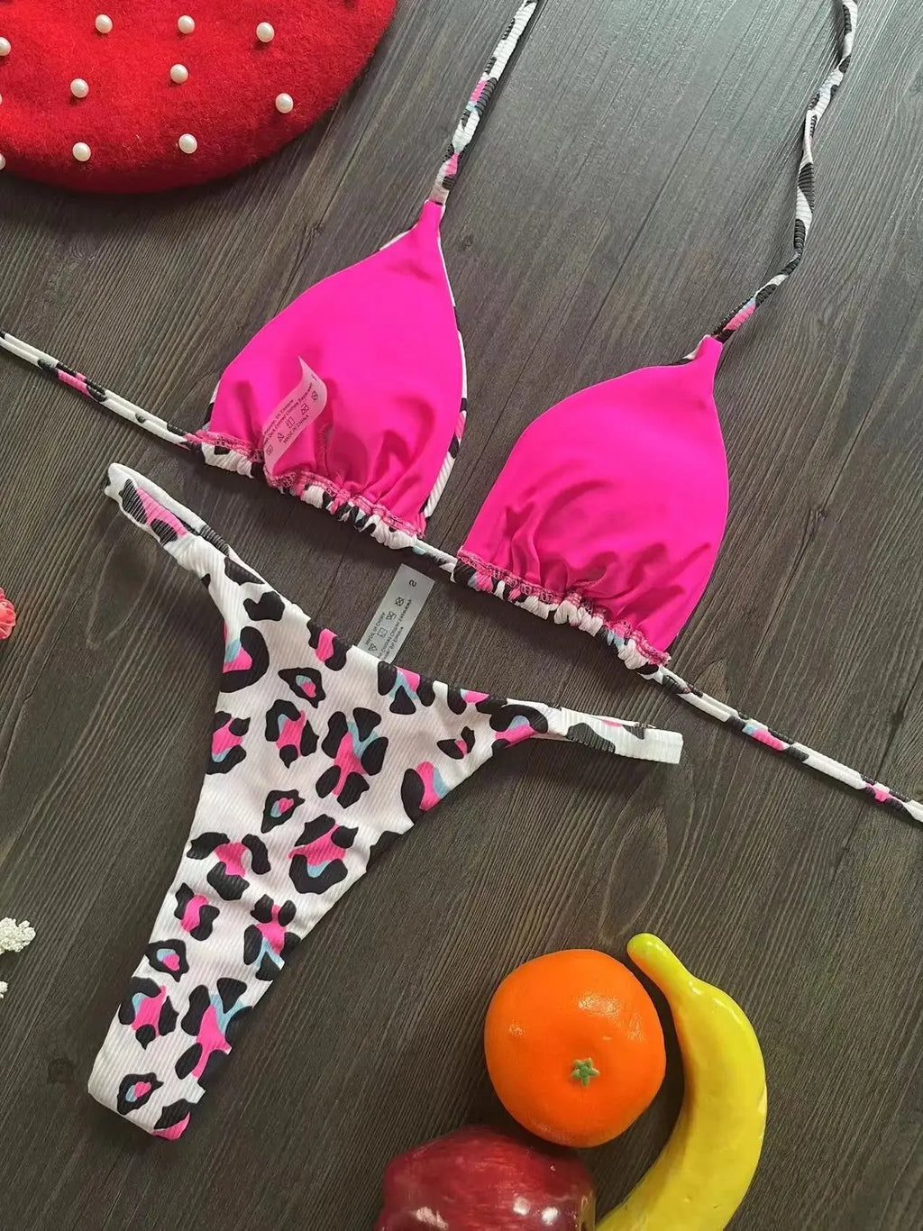 Women's printed bikini swimsuit set on a hanger, showing quick-dry fabric and cotton-lined briefs.