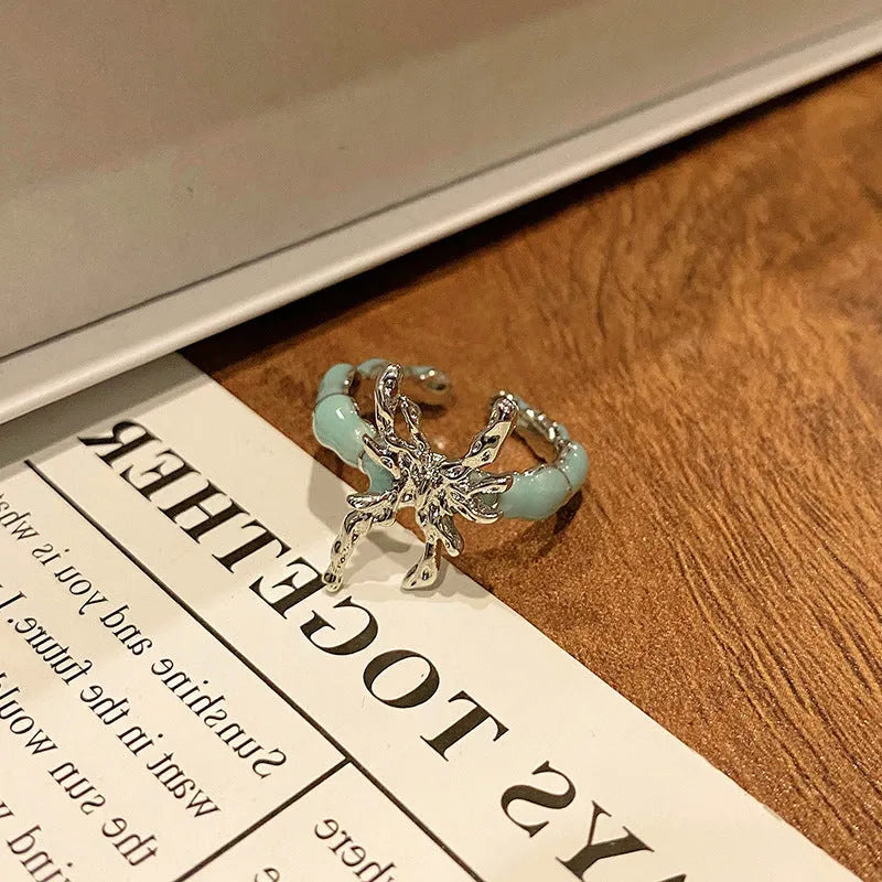 Copper butterfly women's ring with drip oil finish in an open-loop design.