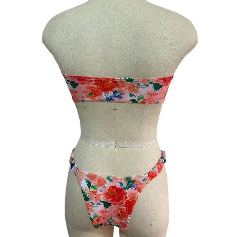 Women's floral print polyester bikini set in blue on a mannequin, showing tube top and briefs.