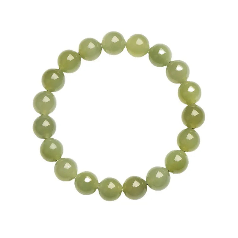 Polished Hetian jade ball bracelet showing spherical beads in ice-like clear water colour on a wrist.