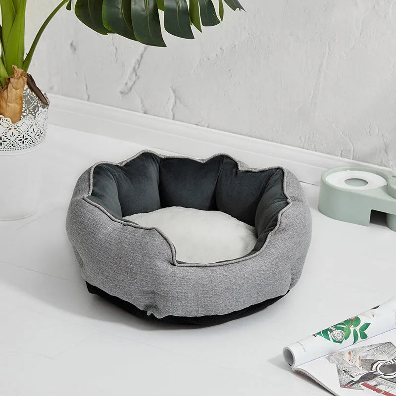Octagonal grey pet bed with soft padded rim and removable inner mat for a small dog
