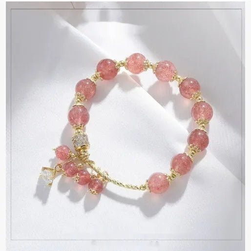 Pink women's crystal bracelet with heart-shaped charms and pearl decorative accents