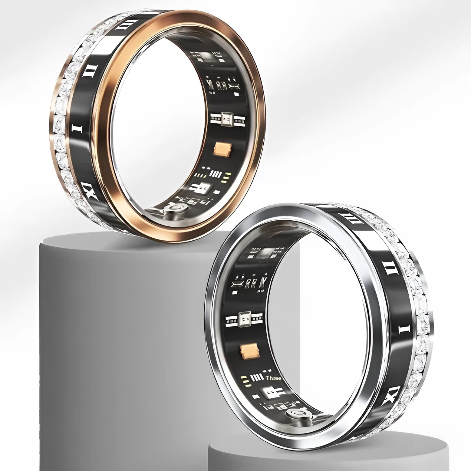 Diamond inlaid smart ring for blood oxygen monitoring in silver and gold colours on a finger.