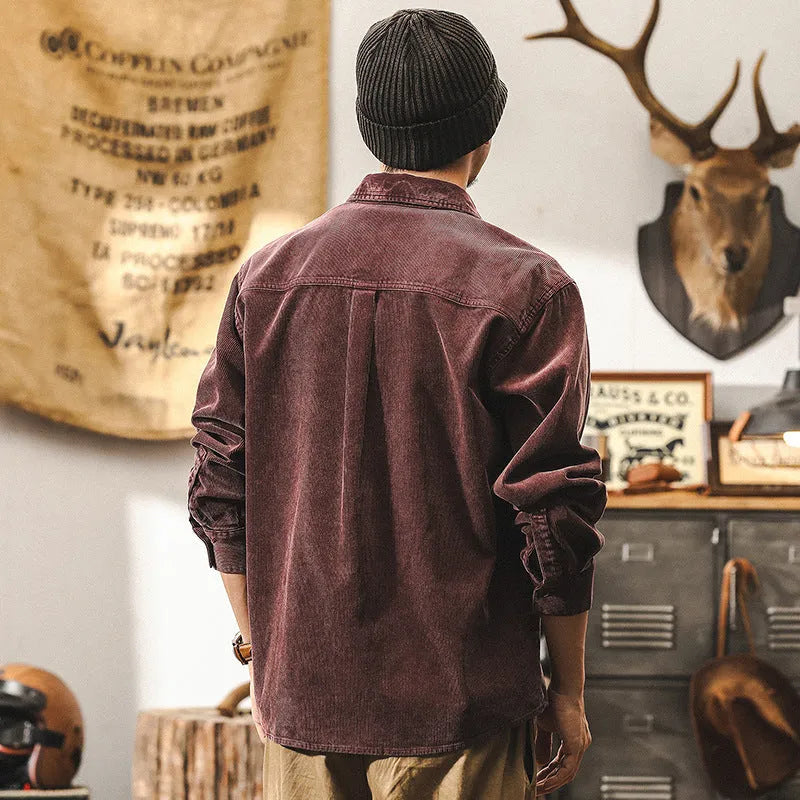 Men's black loose-fit long-sleeved corduroy shirt jacket on a hanger