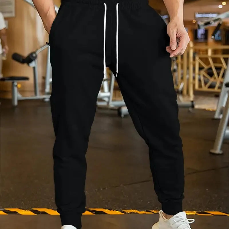 Men's loose-fit linen-style leisure trousers with an elastic drawstring waistband, shown in a neutral colour.