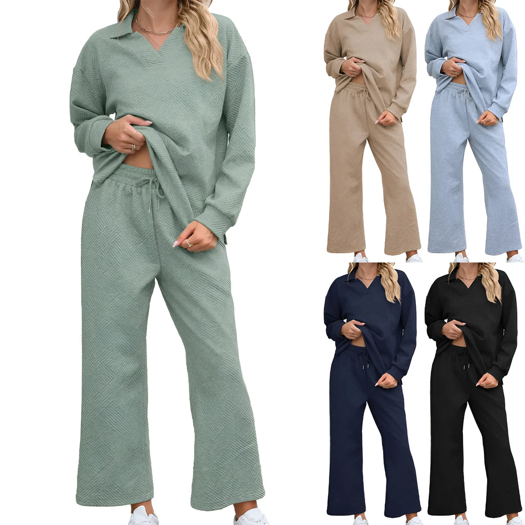 Women's solid colour knitted jacquard sweater and trousers co-ord suit on a hanger.