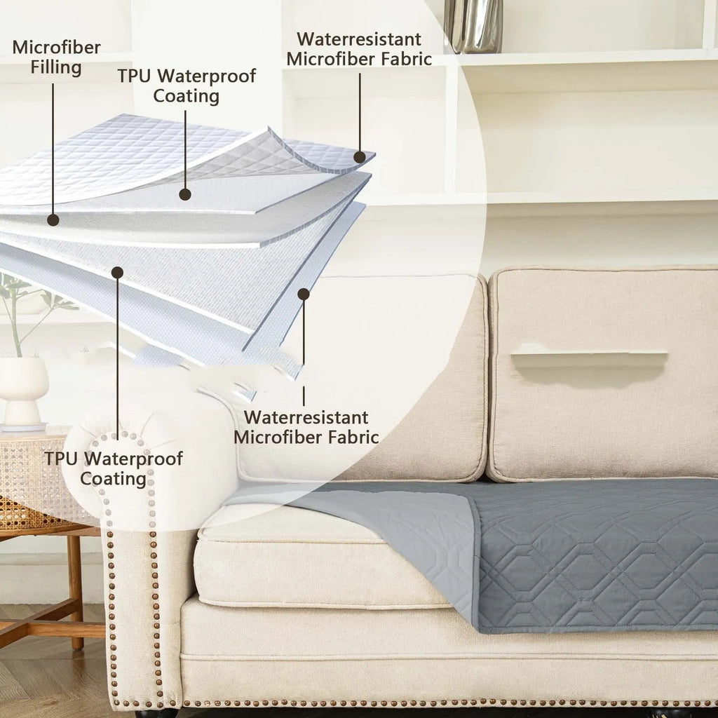 Double-sided waterproof dog sofa cushion in dark grey and light grey contrasting colours on a sofa.