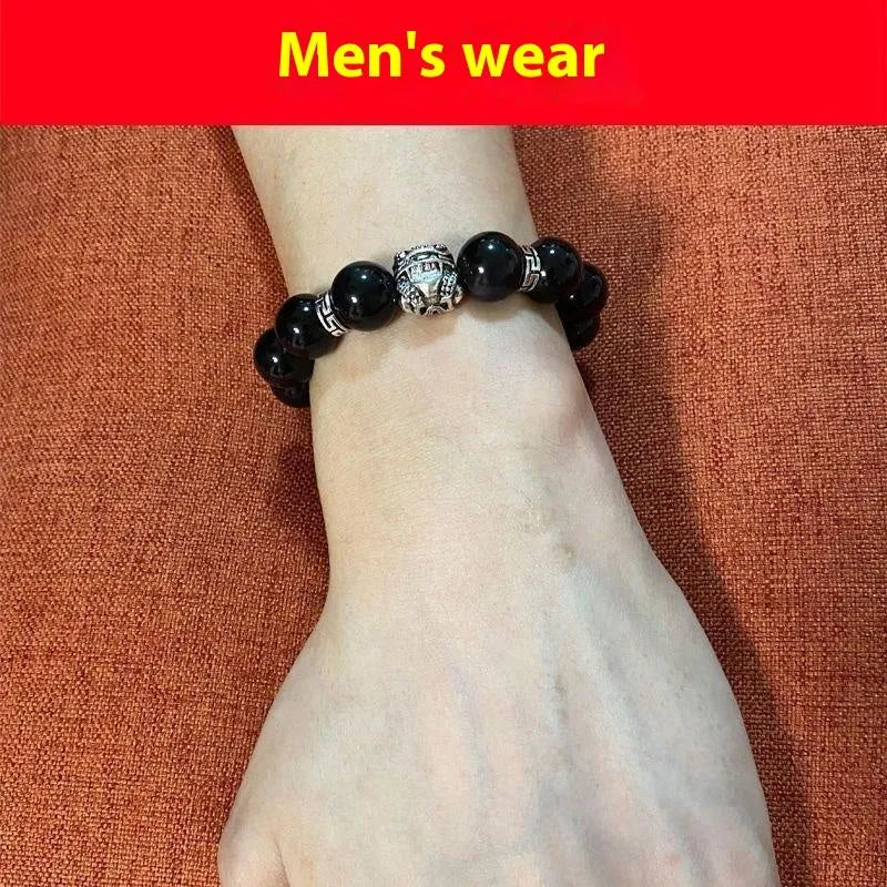 Natural obsidian bracelet with silver 999 clasp in 10mm or 12mm size on a wrist.