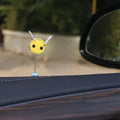 Small plush swing spring bee car decoration ornament on a 3cm scale grid.