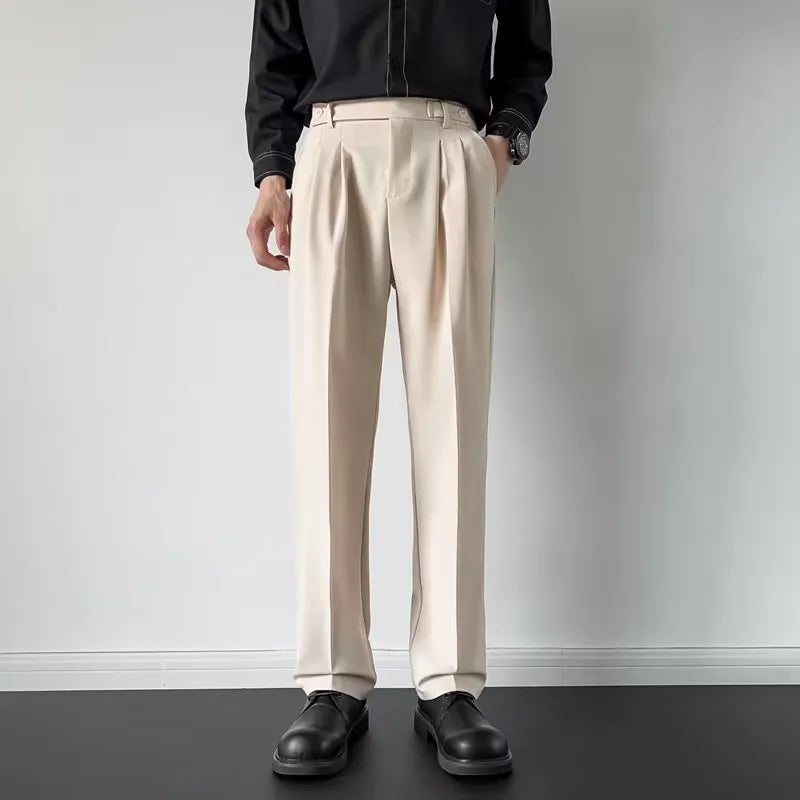 Men's straight-leg loose-fit suit trousers in apricot colour on a hanger.